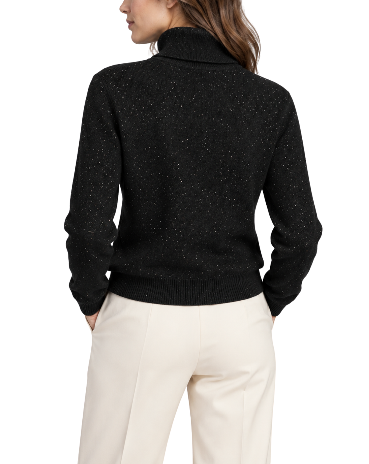 A woman shown from the back wearing a black knit turtleneck sweater with subtle silver speckles and cream-colored trousers, against a plain white background.
