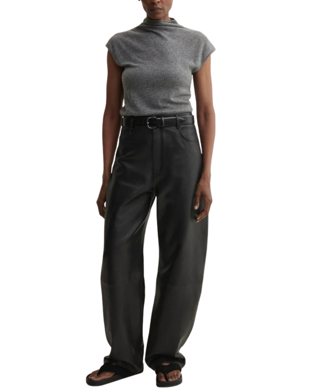 A model wearing a gray ribbed mock-neck cap-sleeve top and black wide-leg trousers with a black belt, paired with black sandals, against a plain white background.