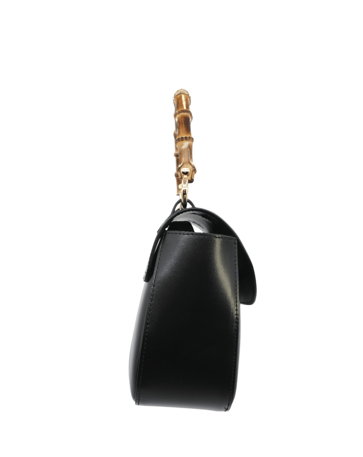 A black leather handbag shown from the side, featuring a distinctive gold-tone bamboo handle attachment.