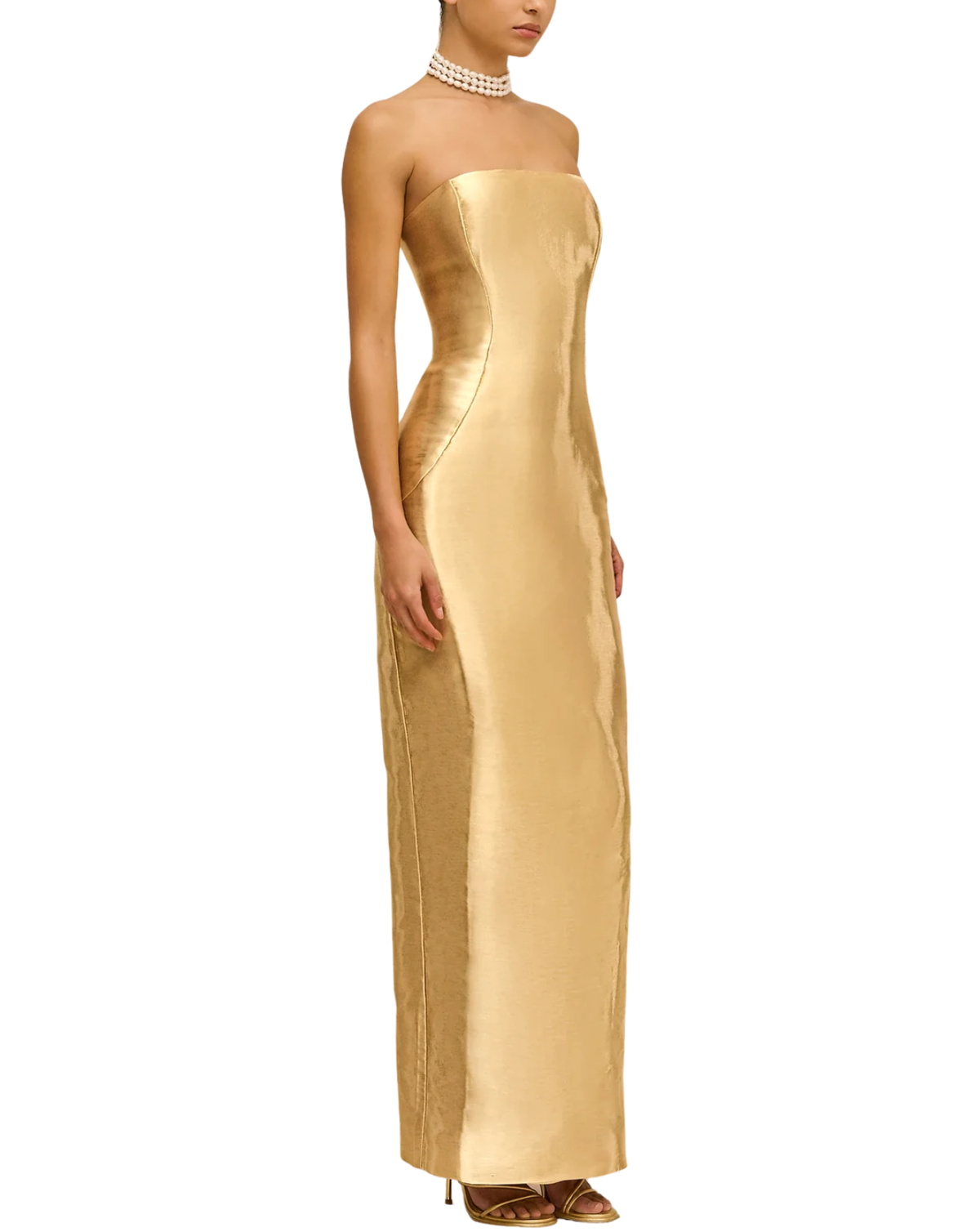 A strapless, floor-length gold gown with a structured bodice and side slit, shown on a model against a plain white background.
