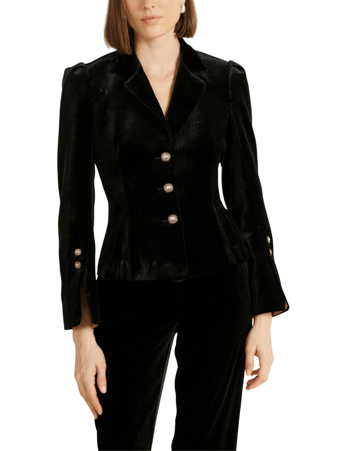 A model wearing a black velvet blazer with gold buttons and matching black velvet trousers, shown against a plain white background.