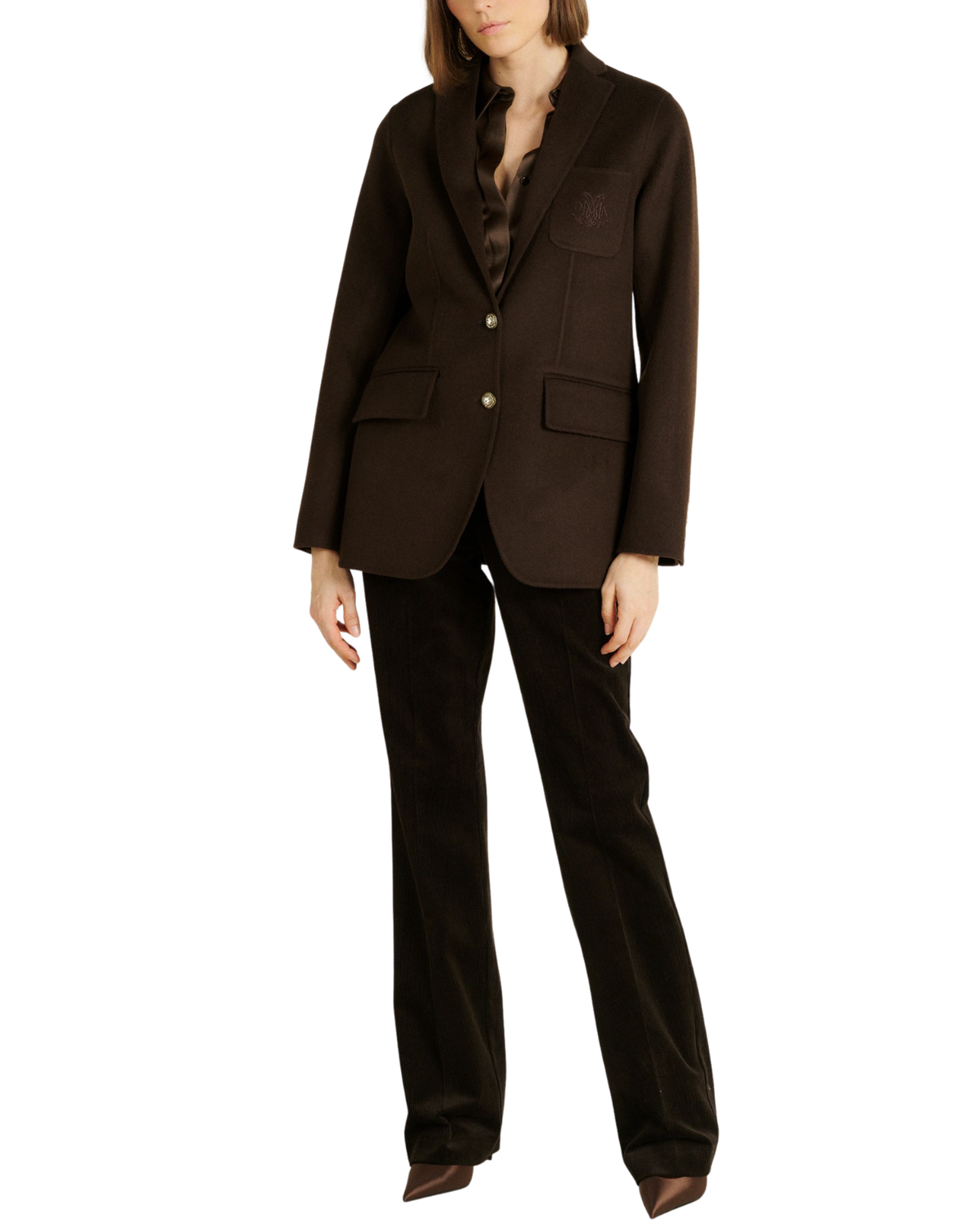 A model wearing a dark brown tailored blazer with matching dark brown trousers, photographed against a plain white studio background.