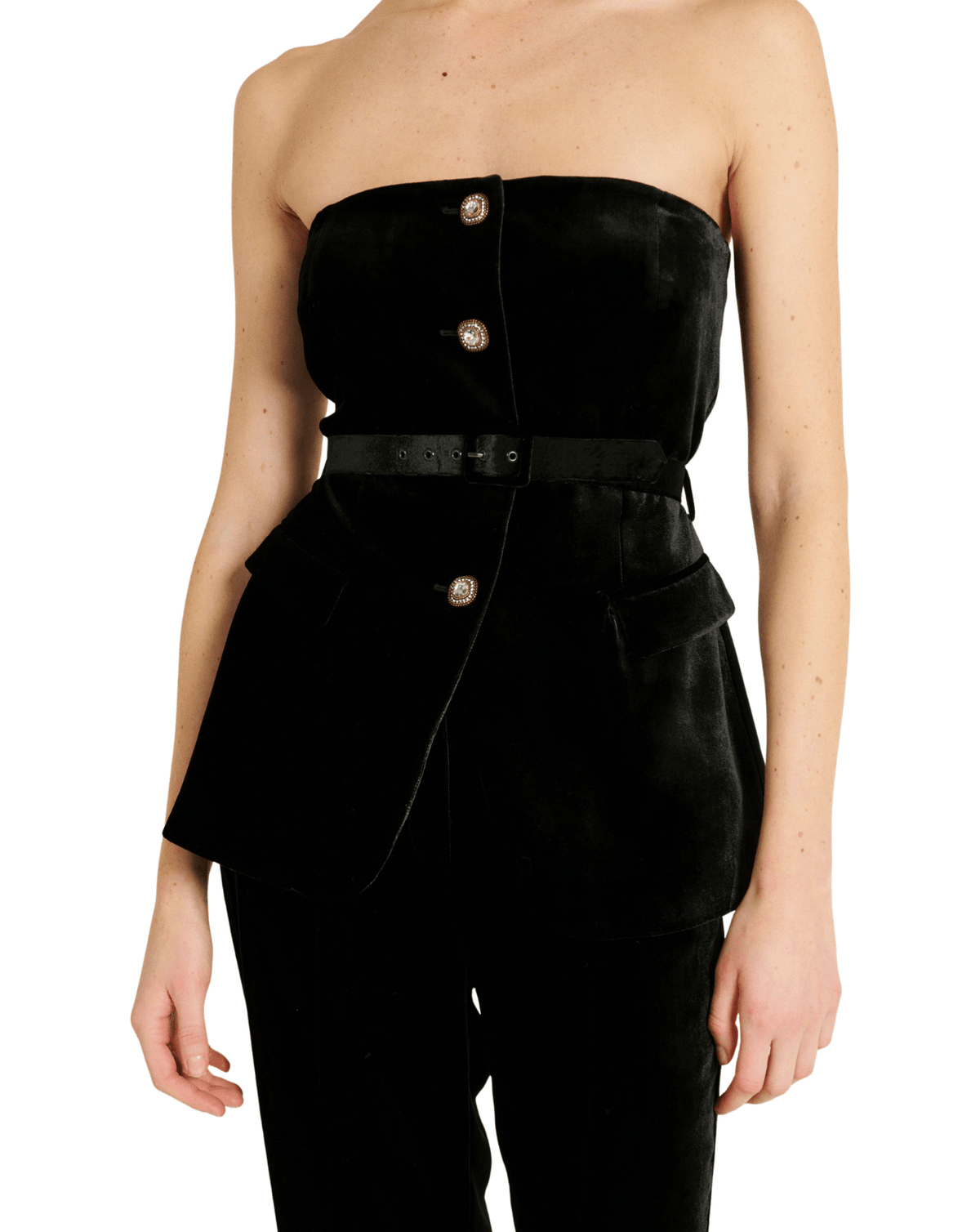 A model wearing a black velvet strapless top with gold buttons, a matching black belt, and black trousers, shown against a plain white background.