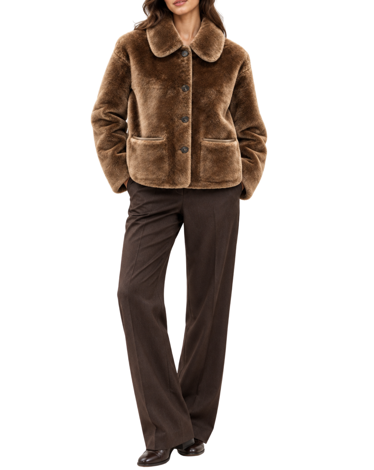 A woman wearing a brown plush faux-fur jacket with a wide collar and front buttons, paired with dark brown wide-leg trousers, shown against a plain white background.