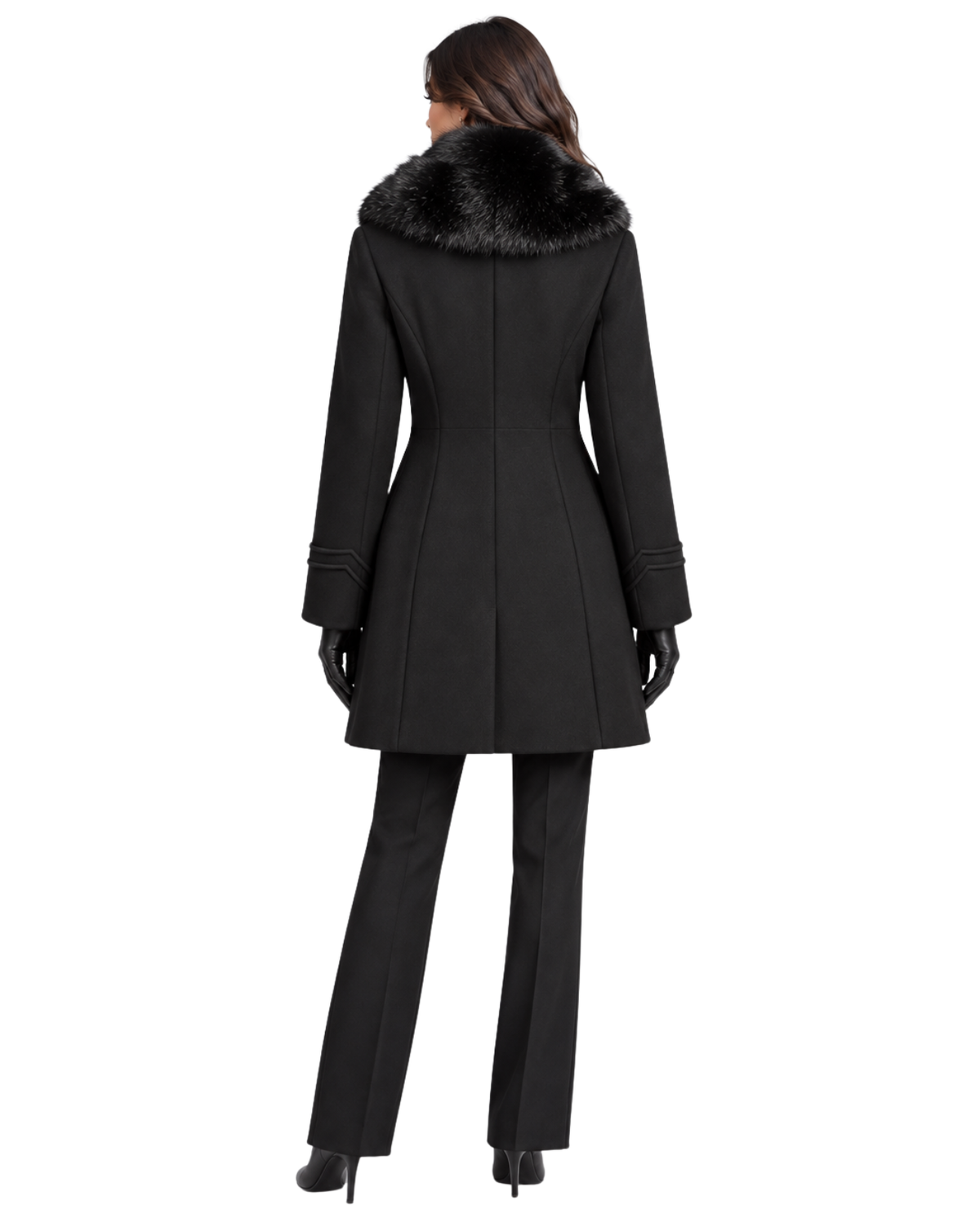 A woman shown from the back wearing a black coat with a dark fur-trimmed collar, black pants, and black gloves against a plain white studio background.