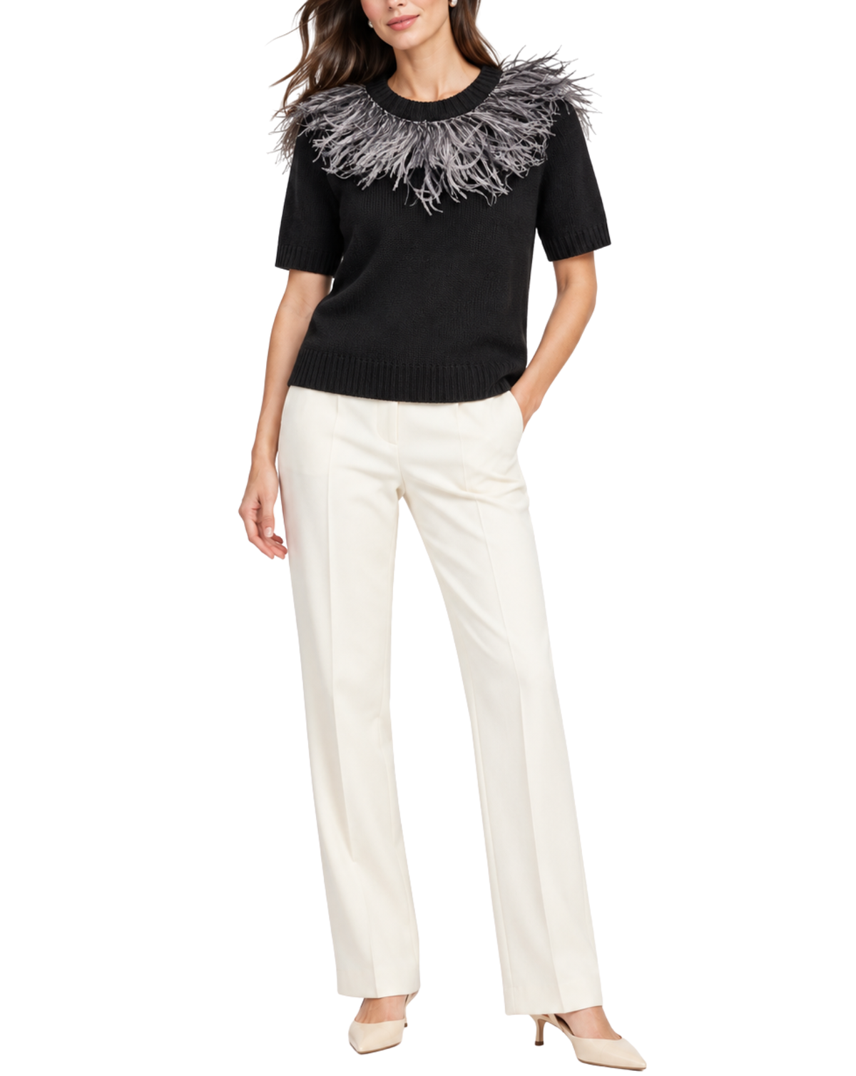 A woman modeling a black short-sleeve knit sweater with a dramatic gray and white feathered collar detail, paired with off-white straight-leg trousers and beige pointed-toe heels against a plain white background.