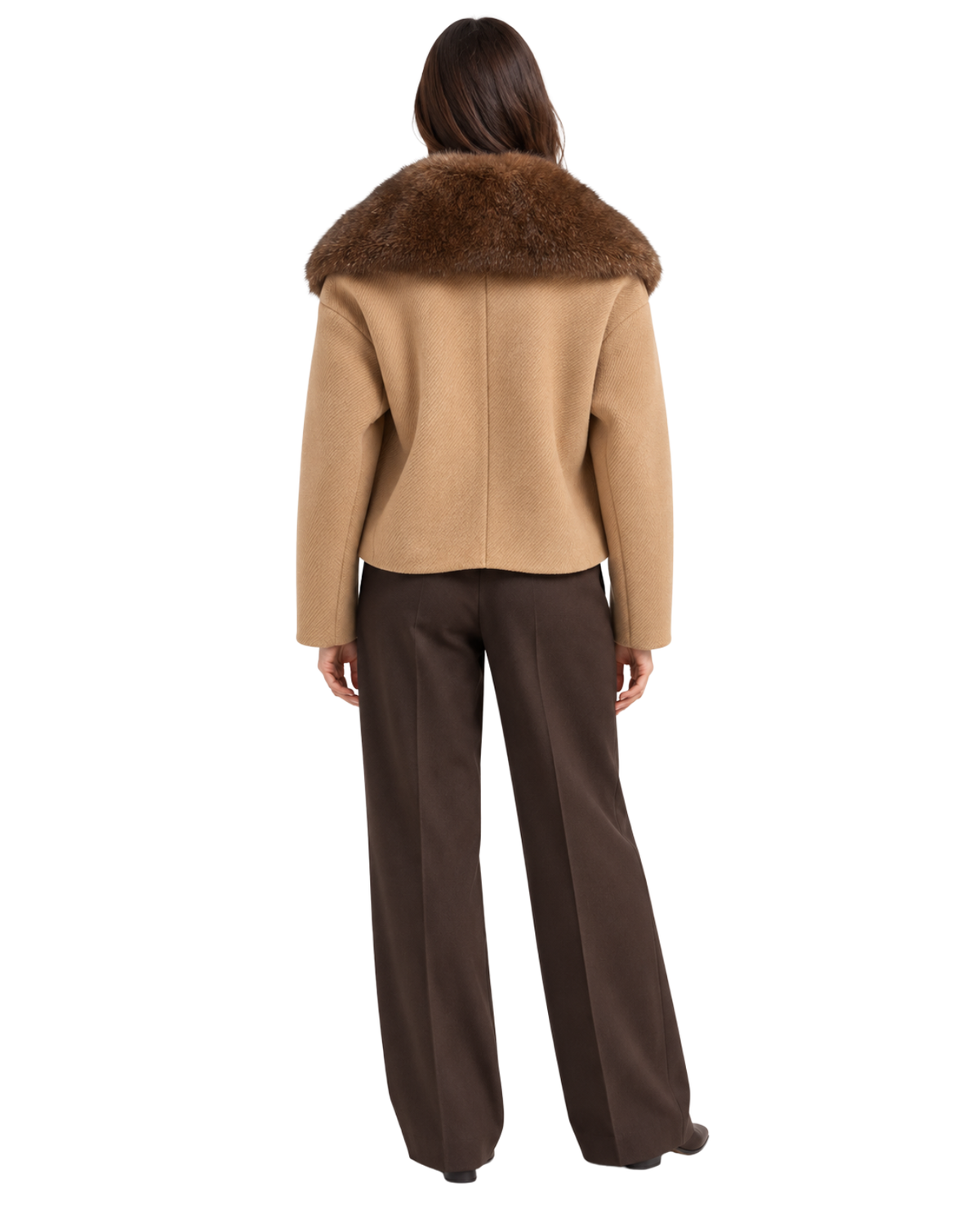 A model shown from the back wearing a cropped camel-colored jacket with a large dark brown fur collar, paired with dark brown wide-leg trousers, against a plain white background.