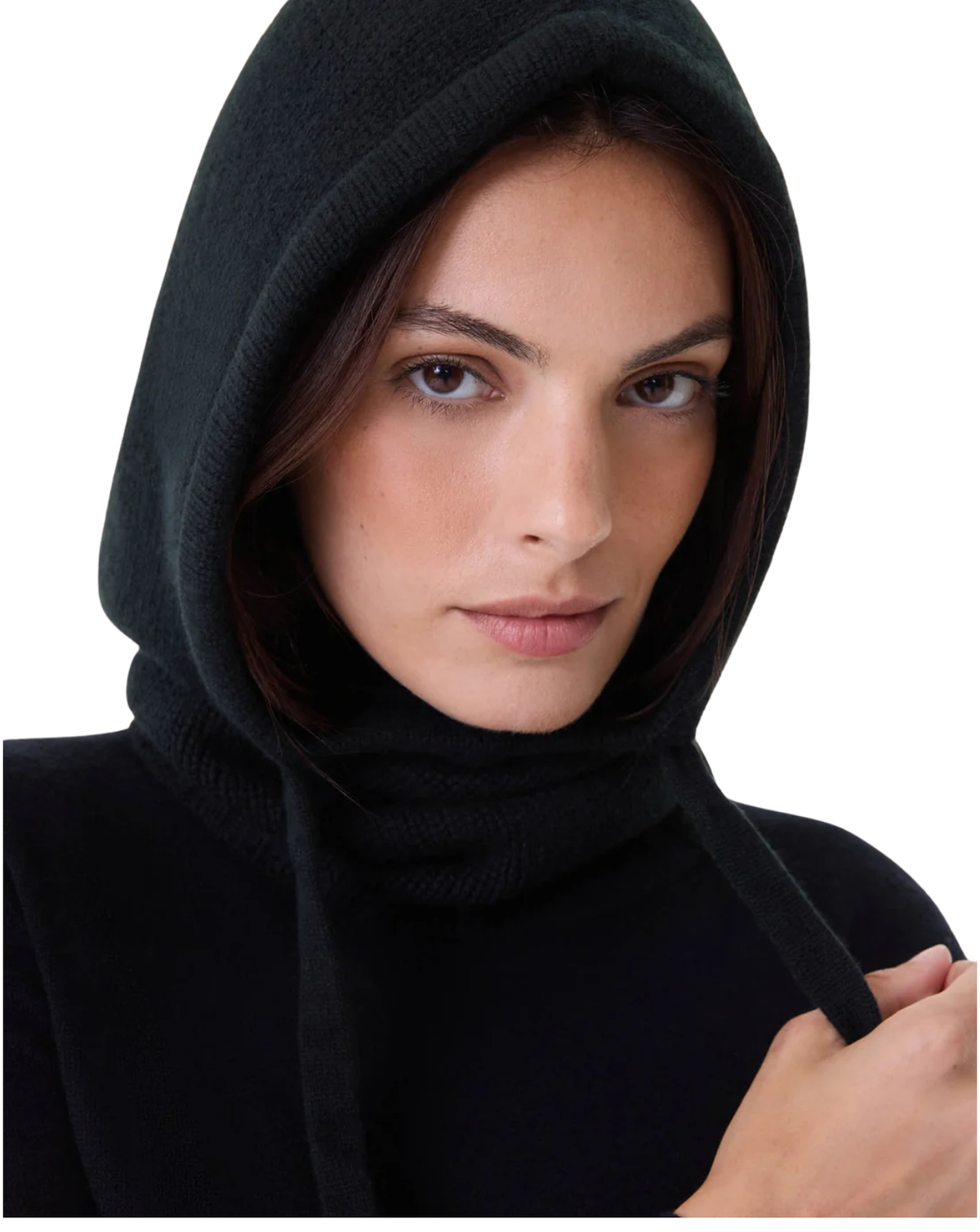 A close-up of a model wearing a black knit hooded cowl-neck sweater against a plain white background.