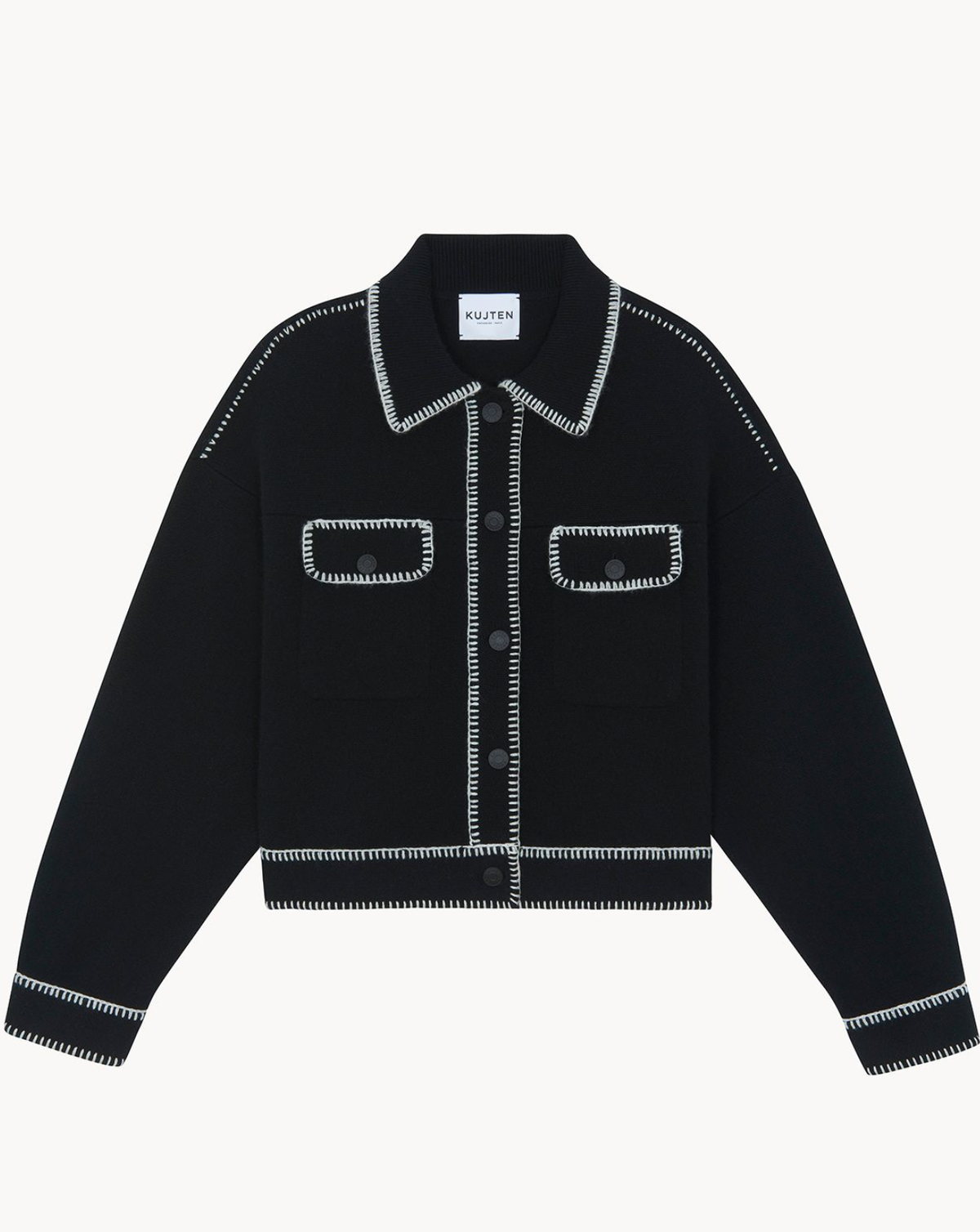 A black cropped knit jacket with white contrast stitching along the collar, pockets, and cuffs, displayed flat against a light gray background.