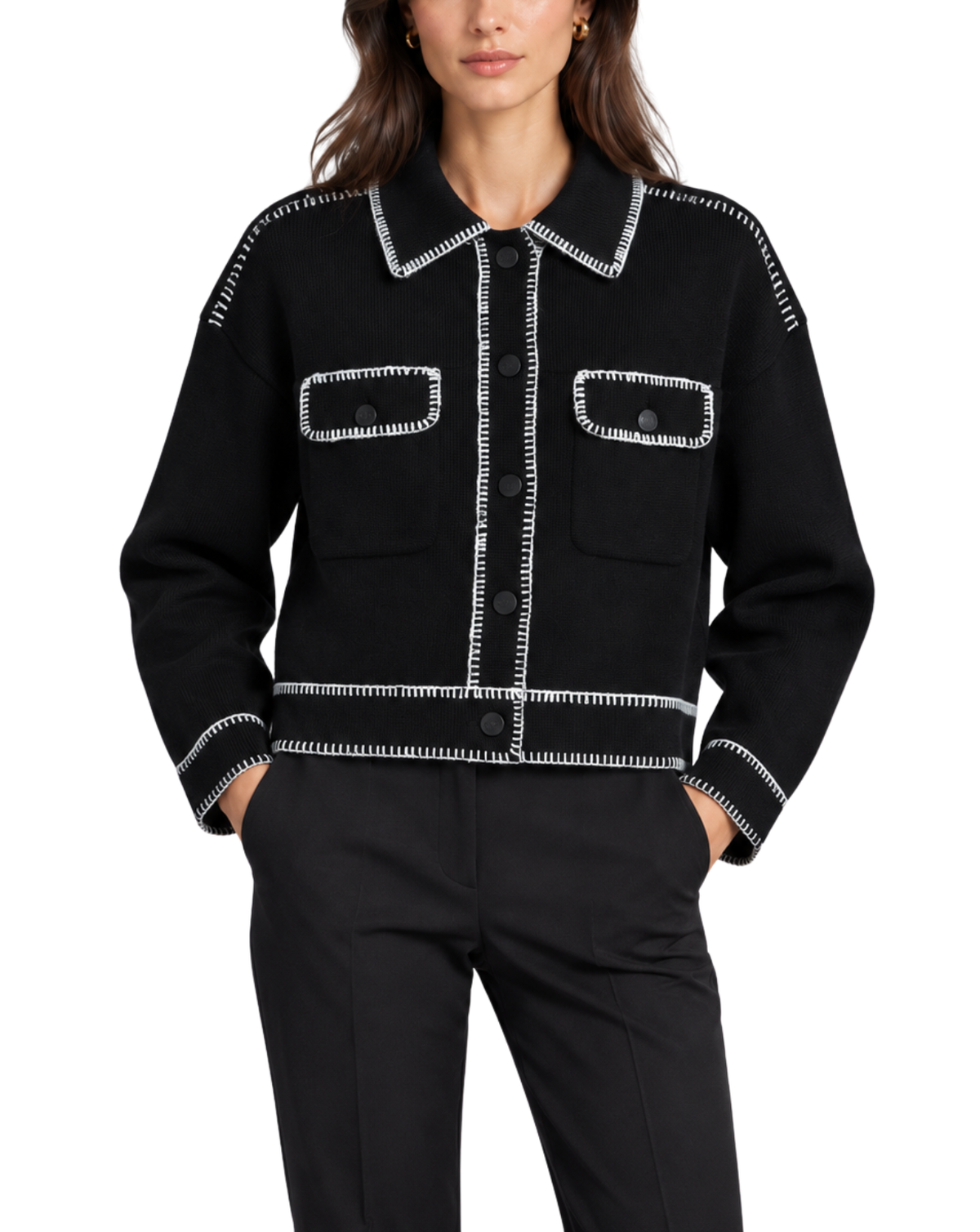 A model wearing a black cropped jacket with white contrast stitching and matching black trousers, photographed against a plain white background.