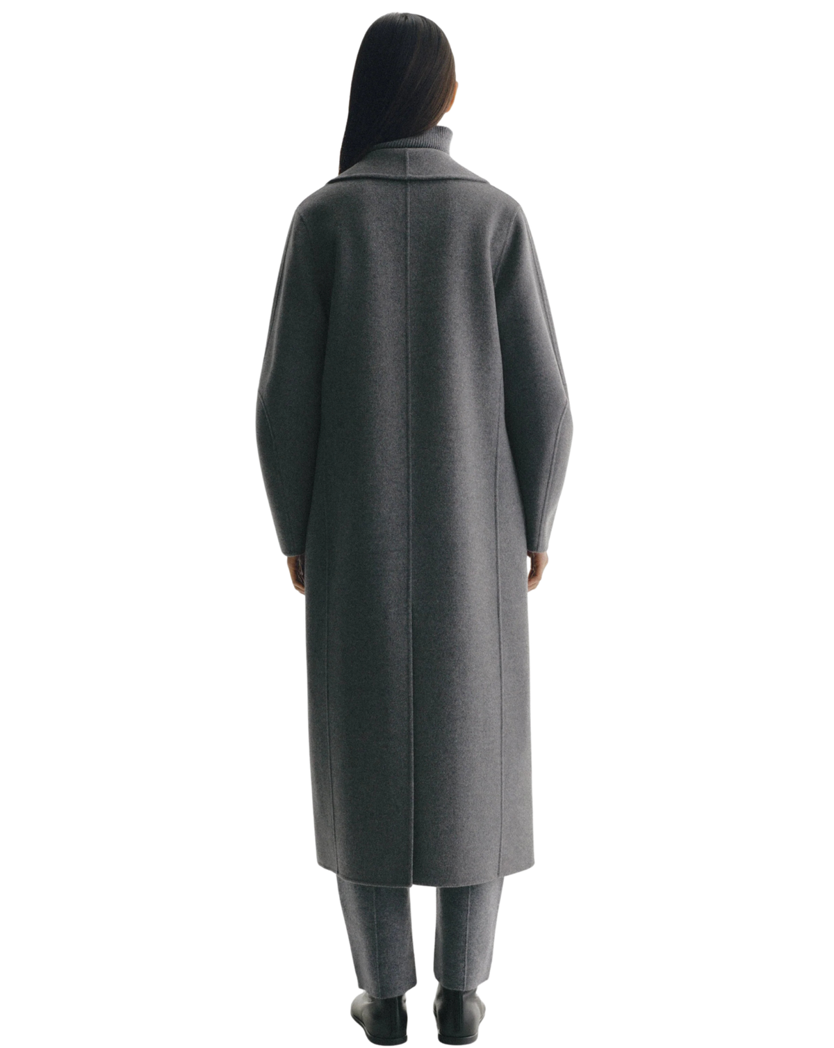 A model shown from the back wearing a long charcoal gray wool coat, matching gray trousers, and black shoes against a plain white background.