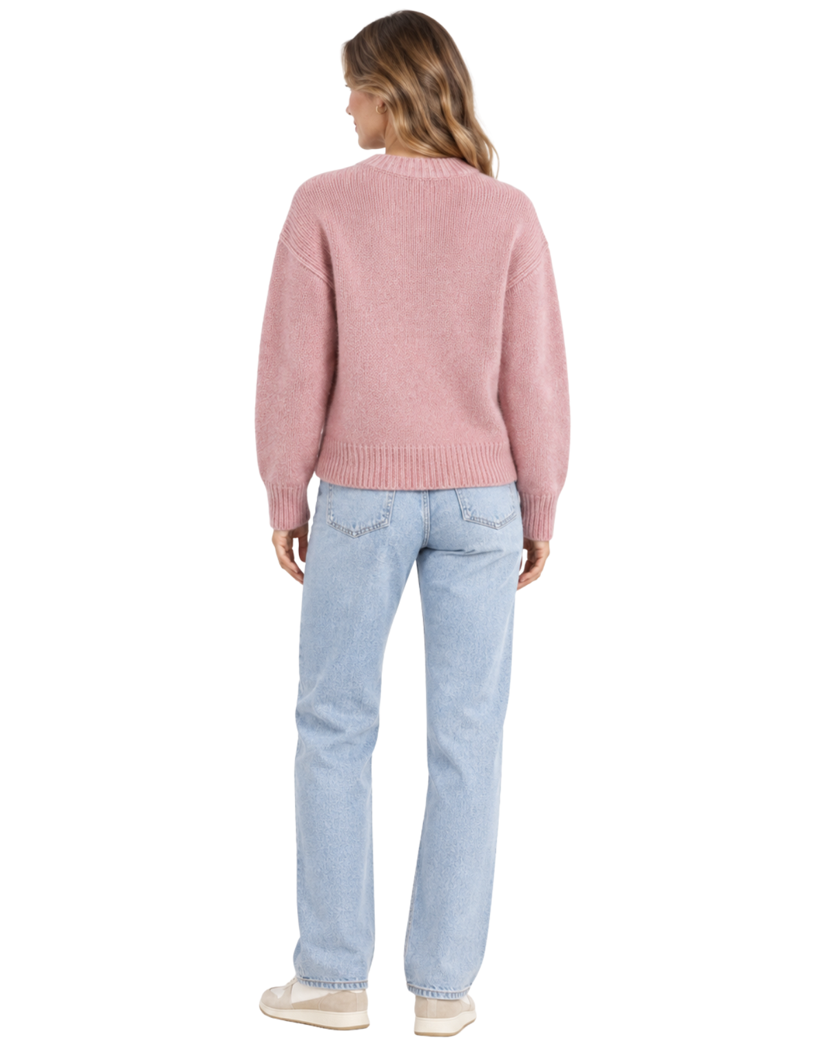 A woman shown from the back wearing a dusty pink knit sweater and light blue jeans against a plain white background.