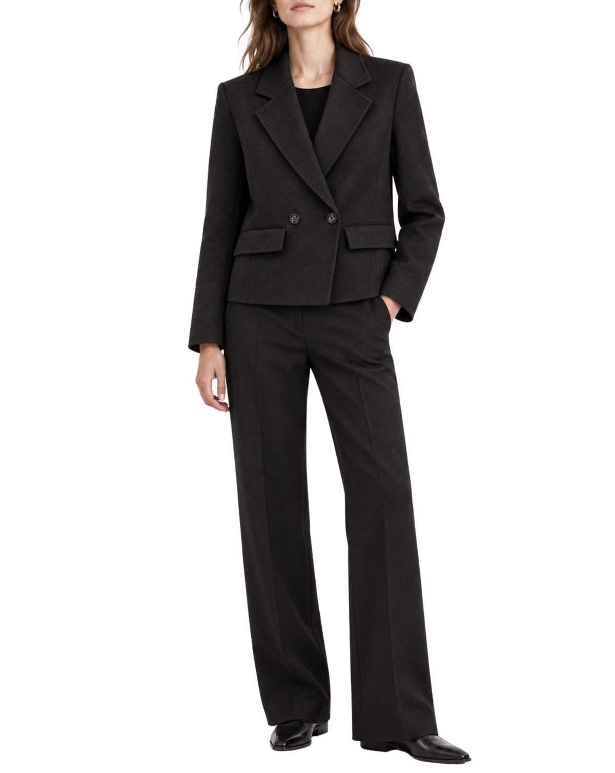 A model wearing a black tailored two-piece suit with a double-breasted blazer and matching wide-leg trousers, paired with black shoes against a plain white background.