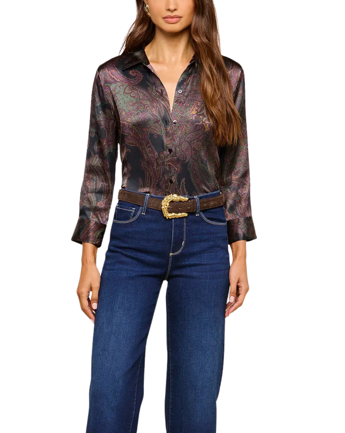 A woman wearing a long-sleeve button-up shirt with a dark paisley pattern in black, brown, and muted red, styled with a brown belt and blue jeans against a plain white background.