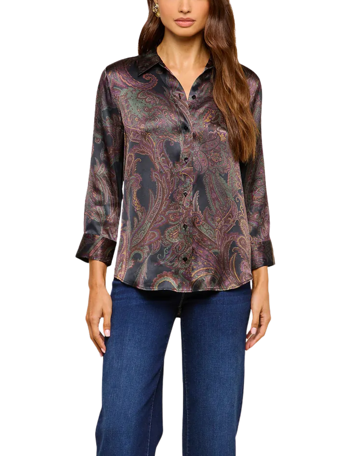 A woman wearing a long-sleeve button-up shirt with a dark paisley pattern in brown, purple, and green, paired with blue jeans, shown against a plain white background.