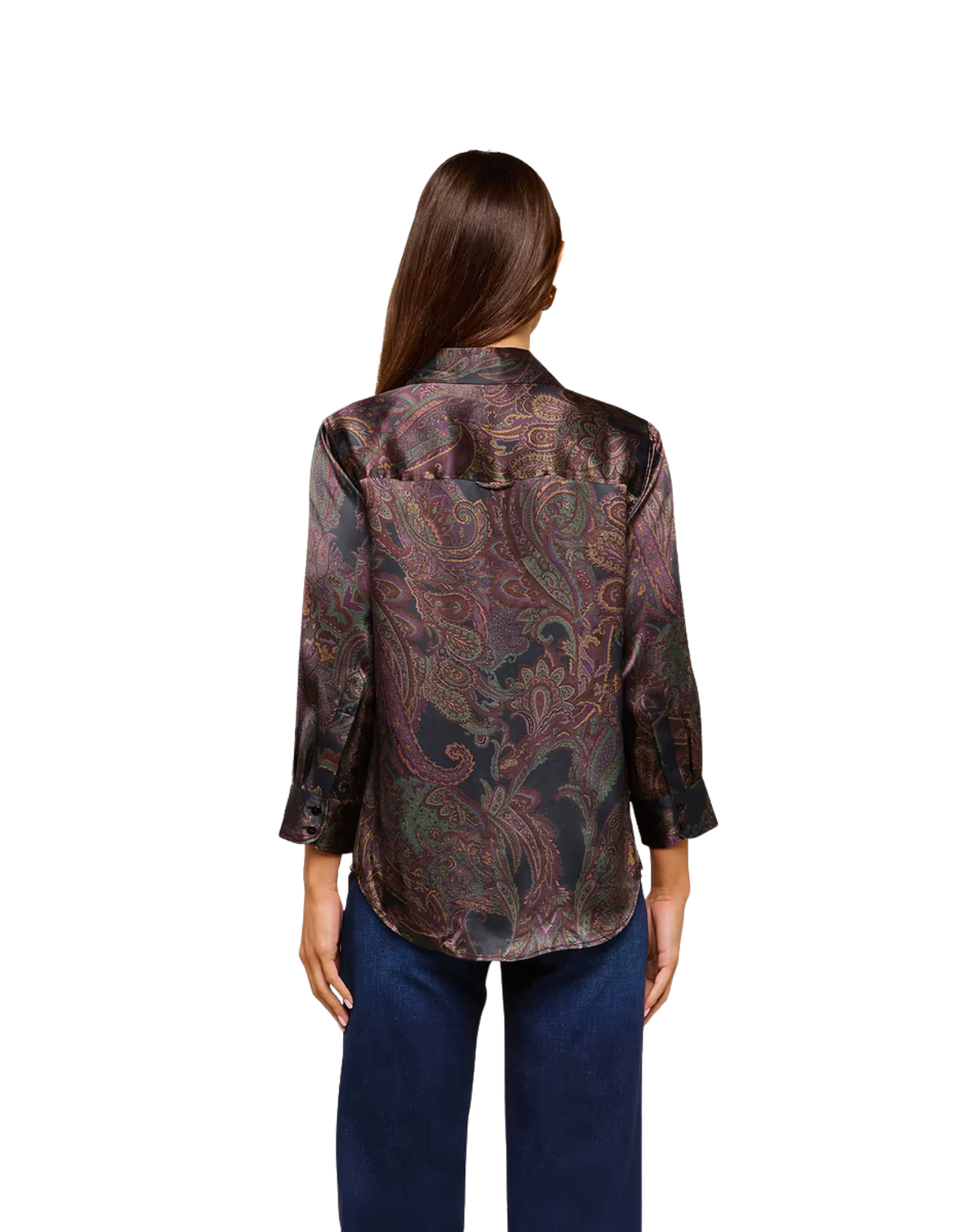 A woman viewed from the back wearing a long-sleeve button-up shirt with a dark paisley pattern in brown, burgundy, and green tones, paired with dark blue jeans, against a plain white background.