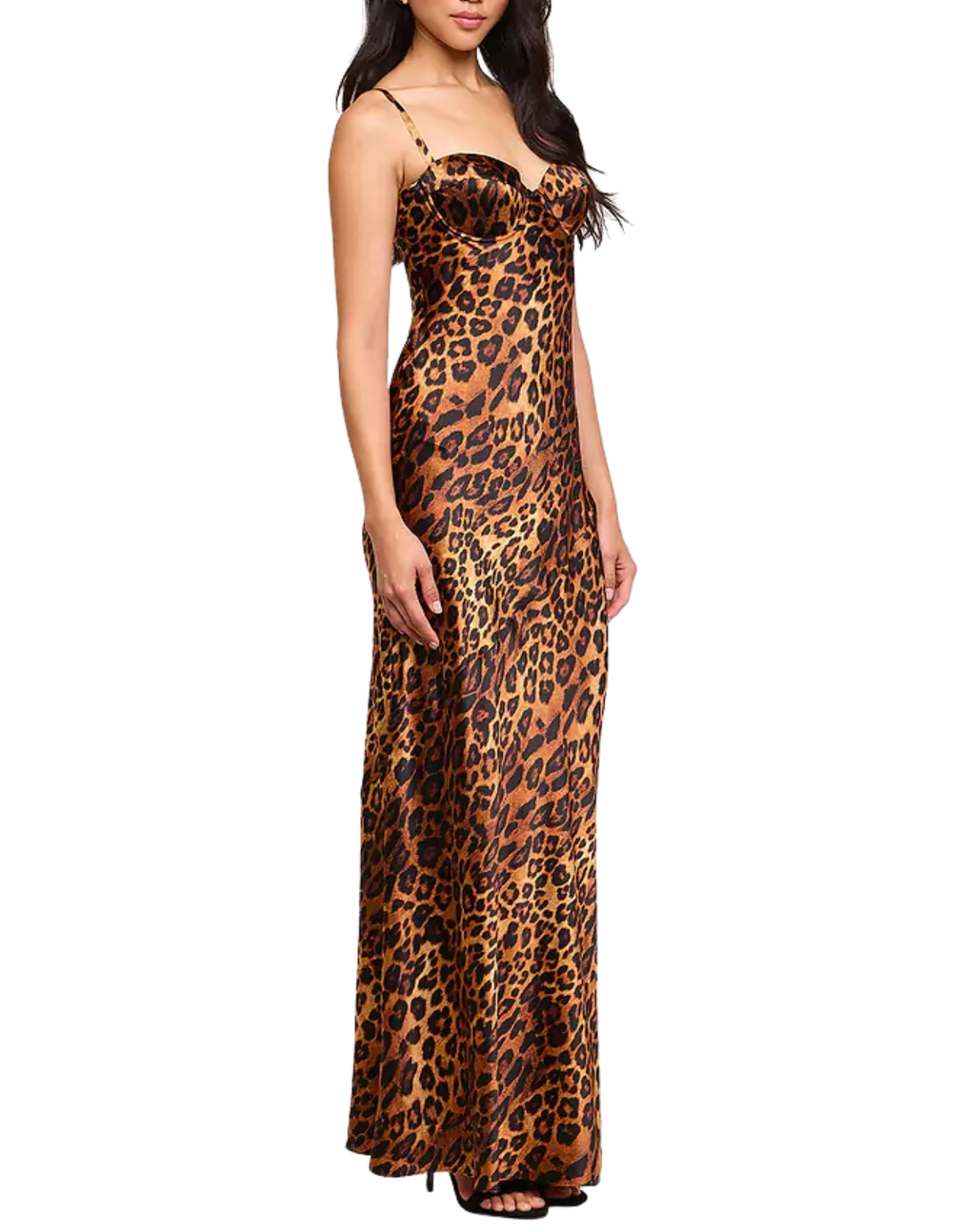 A woman modeling a floor-length leopard-print maxi dress with thin straps and a fitted silhouette, shown against a plain white studio background.