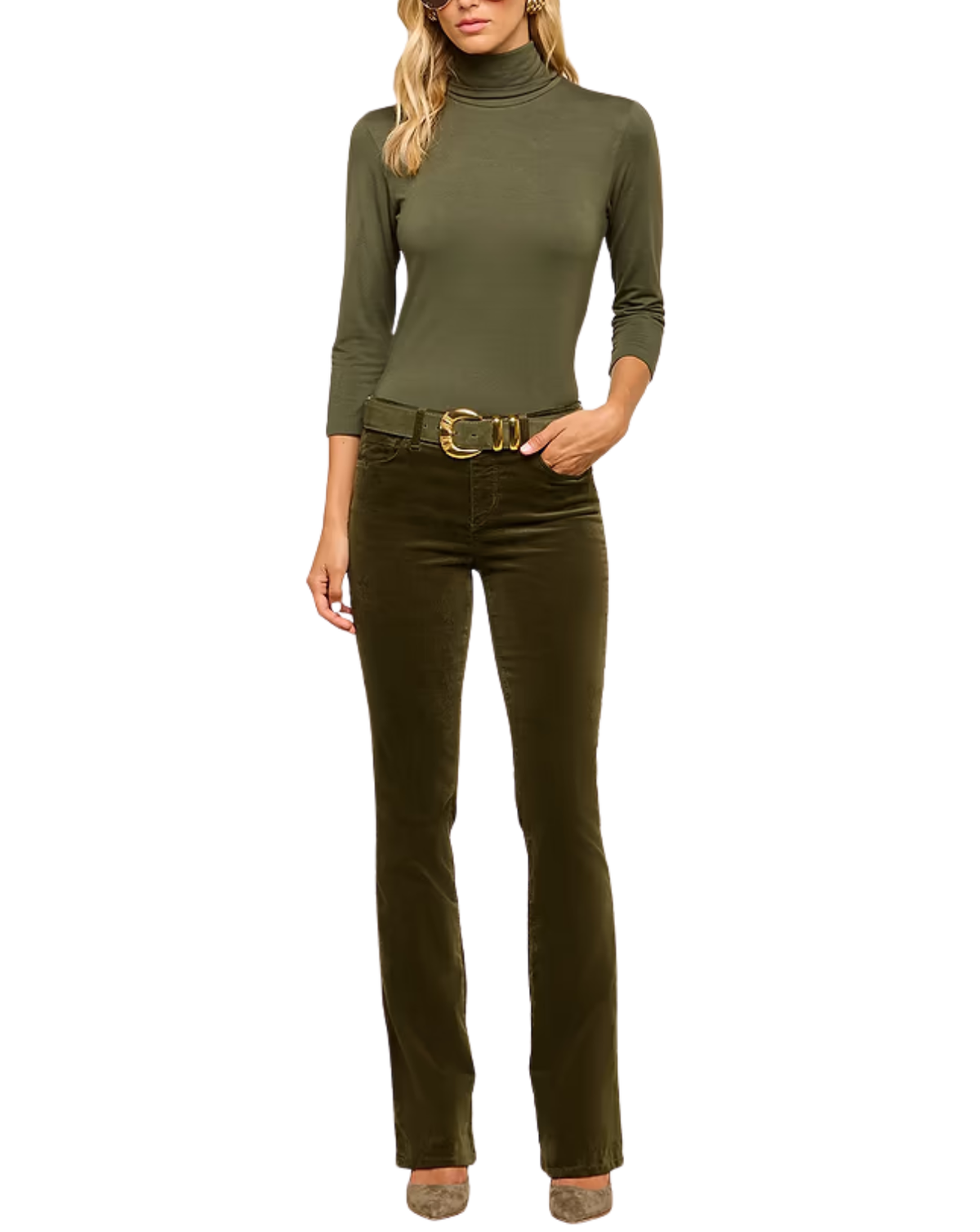 A woman modeling a fitted olive green long-sleeve turtleneck top paired with dark olive green pants and a gold-tone belt, shown against a plain white background.