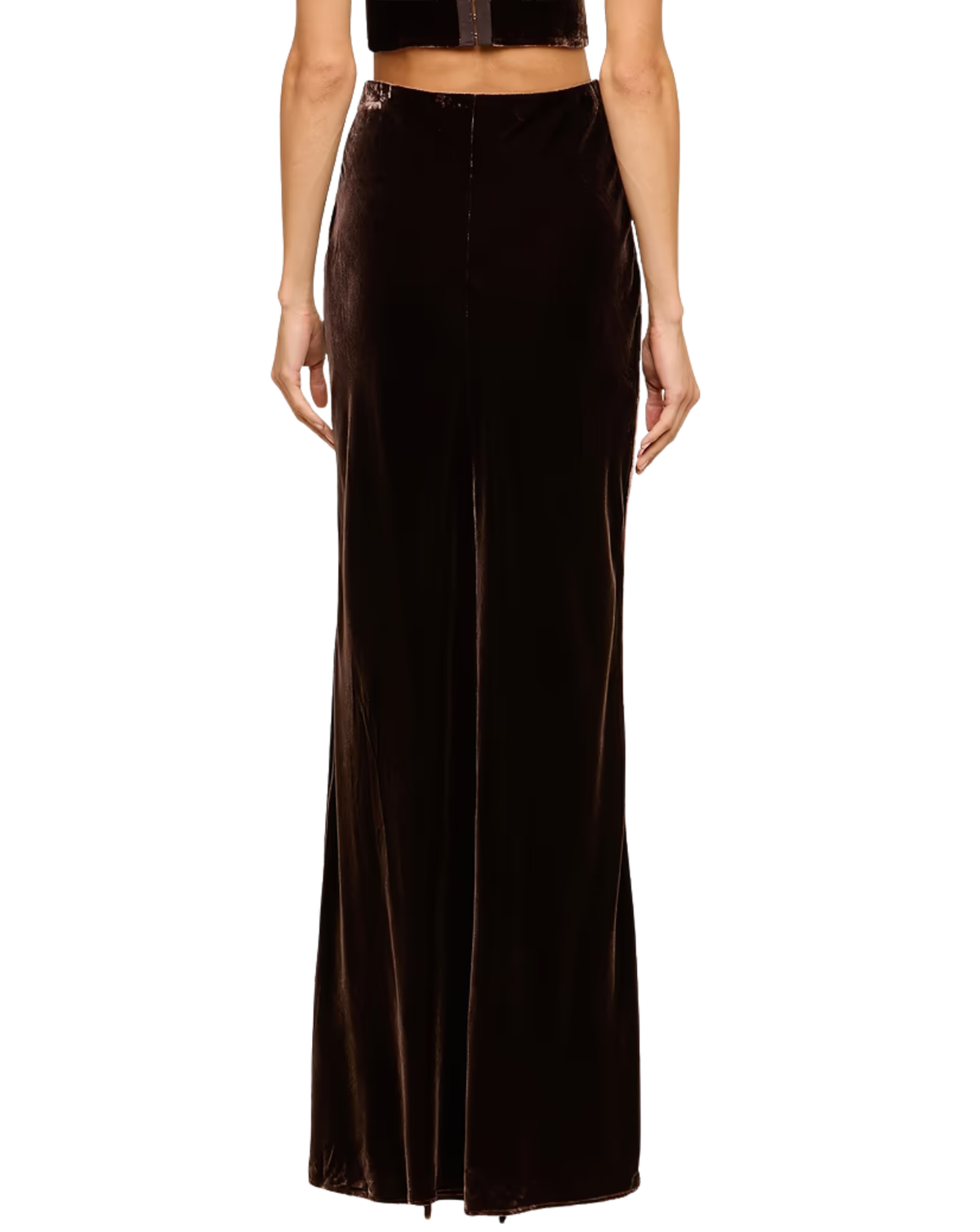 A model wearing a dark brown velvet maxi skirt with a front slit, paired with a matching dark brown velvet crop top, shown against a plain white background.