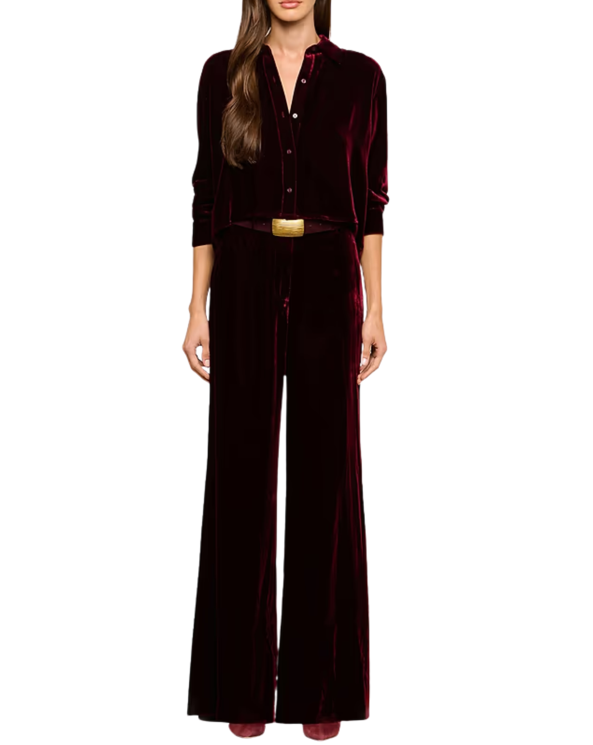 A woman modeling a deep burgundy velvet jumpsuit with a matching belt and gold buckle, shown against a plain white background.
