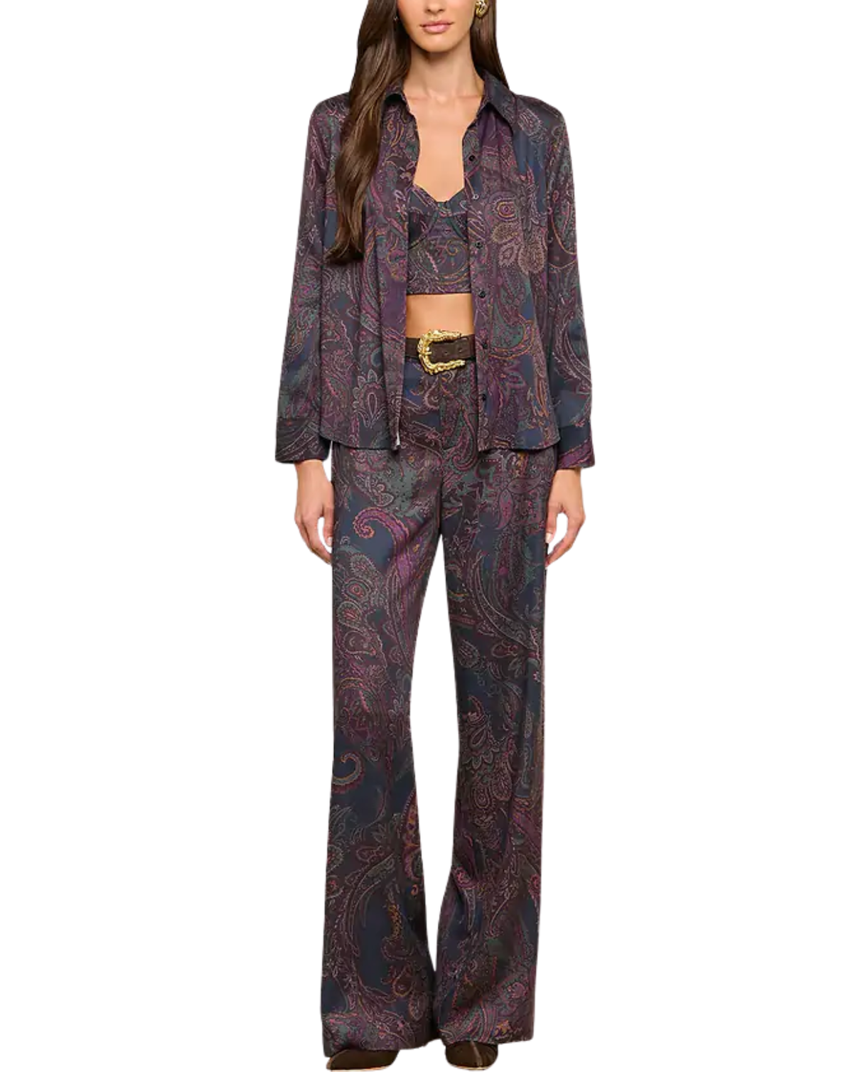 A model wearing a matching three-piece pantsuit in a dark paisley pattern with purple, pink, and blue tones, featuring a long-sleeve button-up blazer, a cropped tie-front vest, and wide-leg trousers.