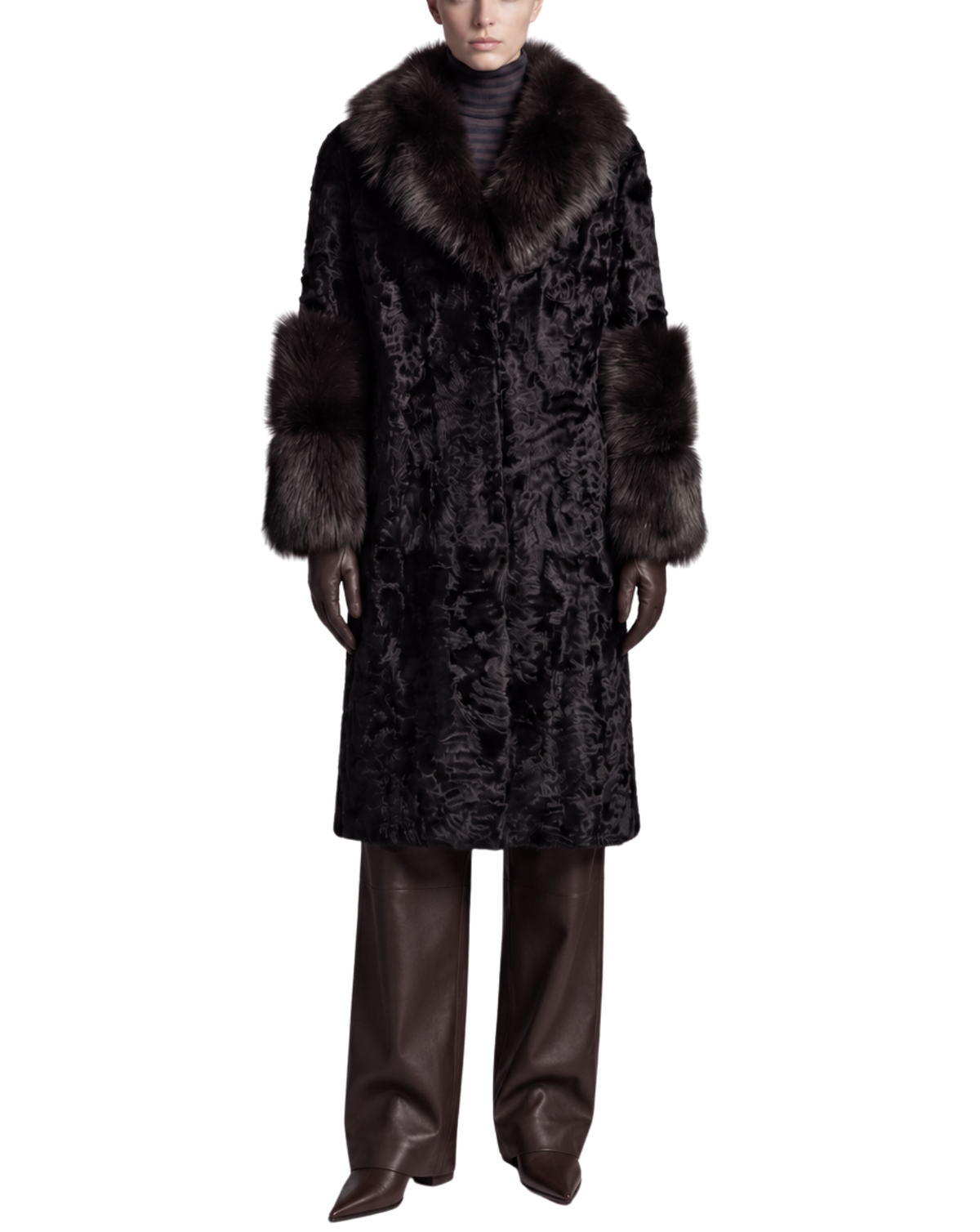 A model wearing a long black textured fur coat with a voluminous dark brown fur collar and matching fur-trimmed sleeves, styled with dark brown wide-leg leather pants against a plain white background.