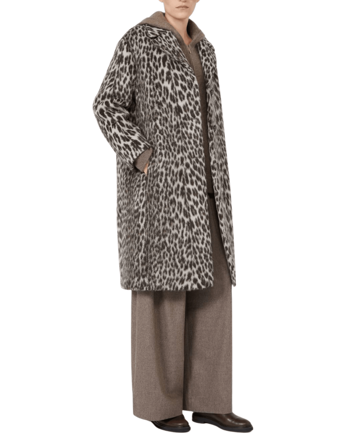 A model wearing a mid-length leopard-print coat over a brown knit top and wide-leg brown trousers, shown against a plain white background.