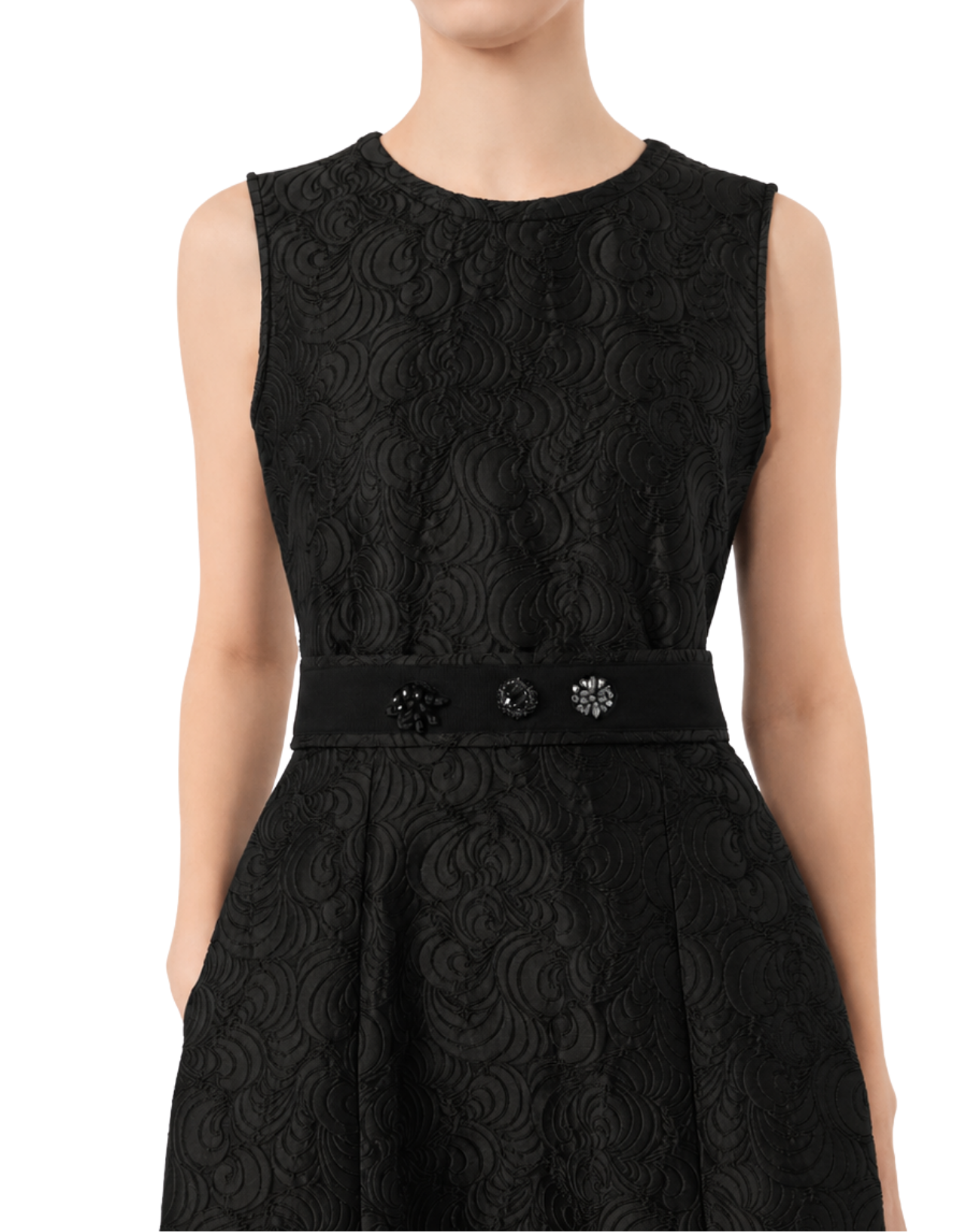 A sleeveless black dress with a textured, swirling jacquard pattern, featuring a matching black waist belt adorned with three decorative dark embellishments, shown on a model against a white background.
