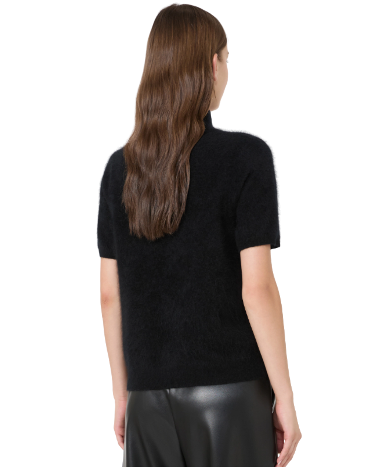 A woman shown from the back wearing a black short-sleeve fuzzy knit mock-neck top and black leather pants against a plain white background.