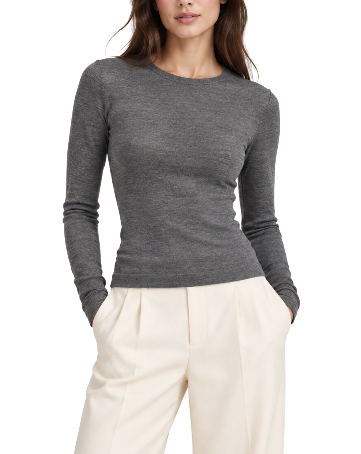 A woman wearing a fitted long-sleeve crewneck sweater in heather gray, paired with cream-colored trousers, shown against a plain white background.
