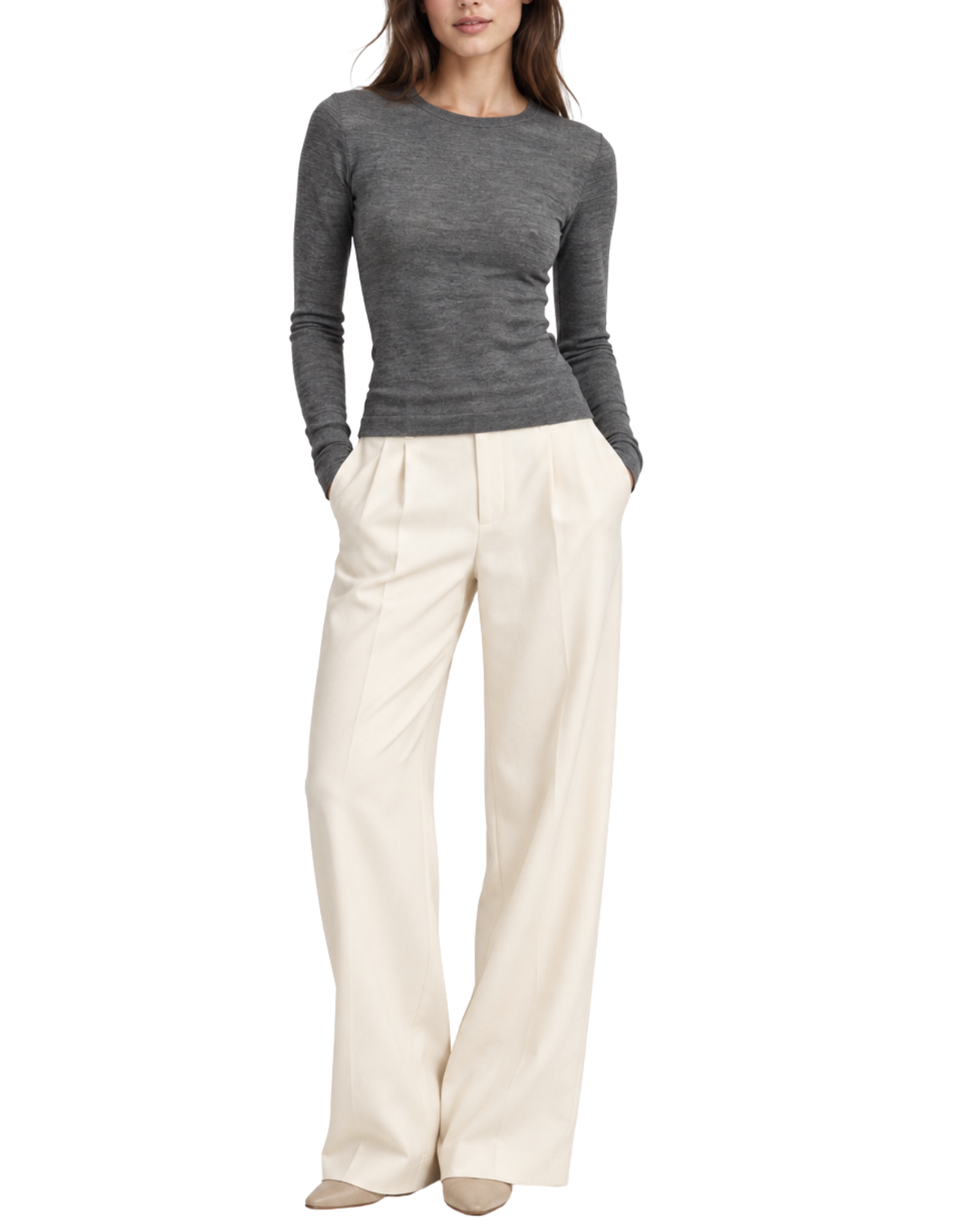 A woman modeling a dark gray long-sleeve knit top and cream wide-leg trousers against a plain white background.