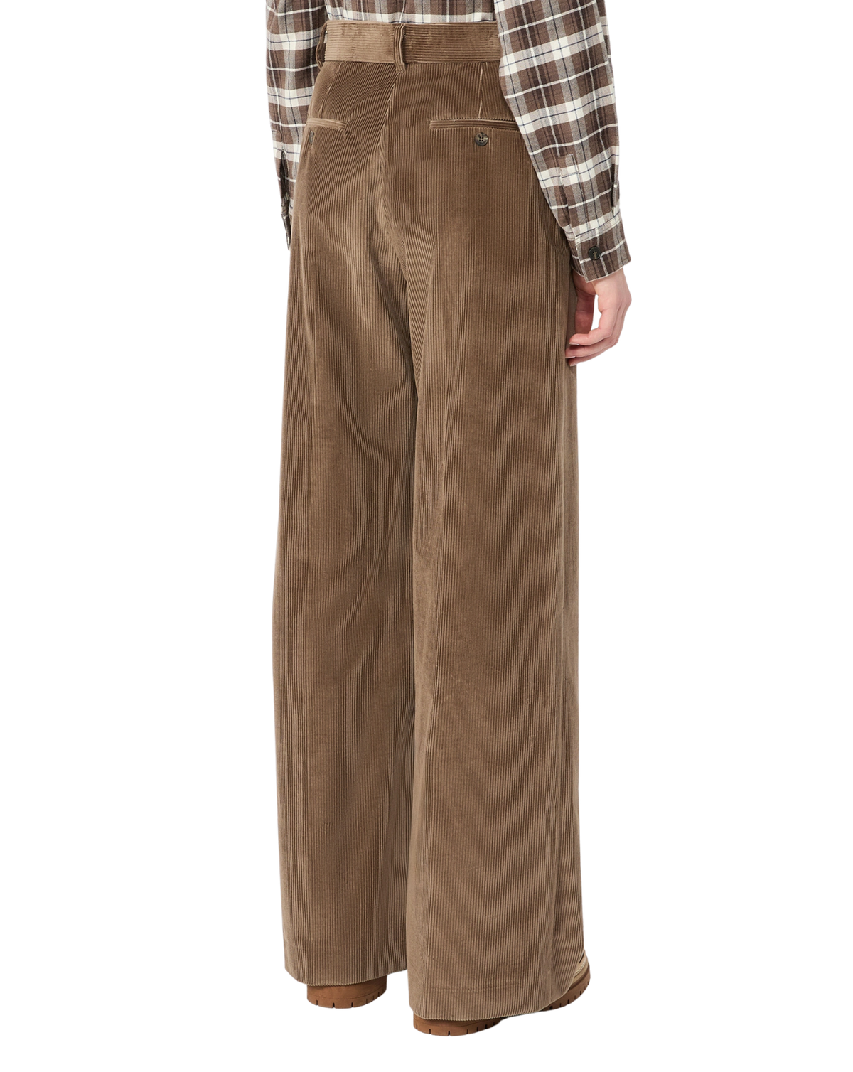A person shown from the back wearing high-waisted, wide-leg brown corduroy trousers and a brown-and-beige plaid flannel shirt, against a plain white background.
