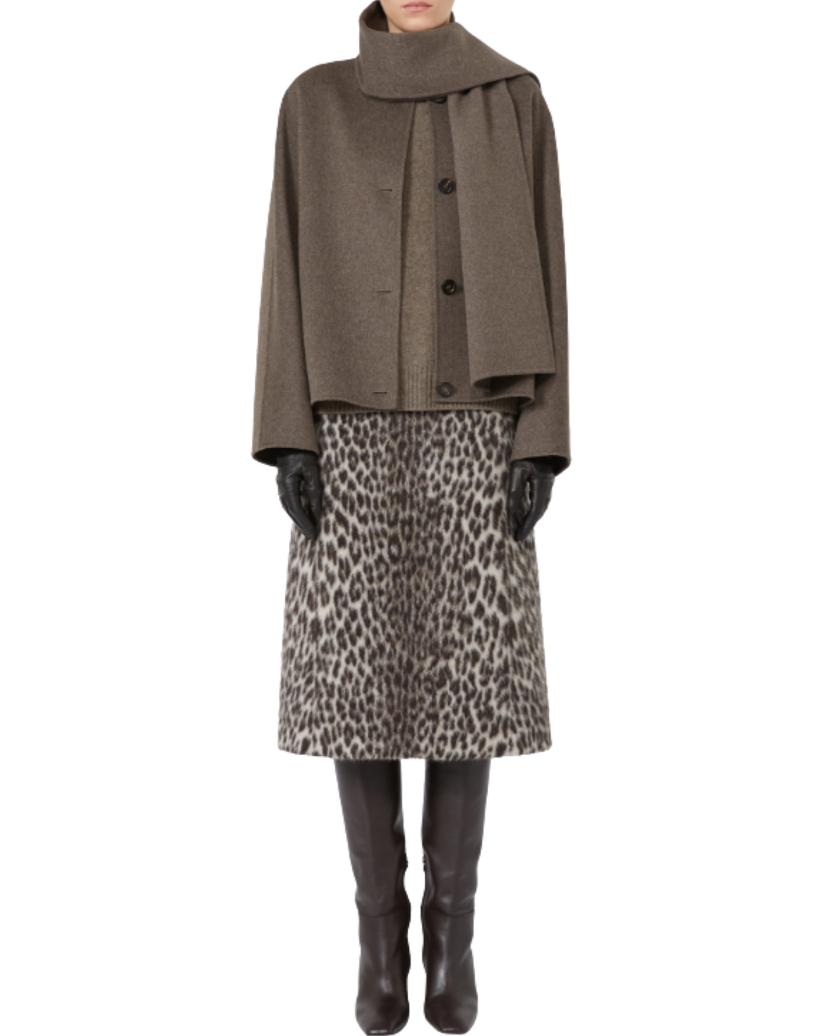 A model wearing a taupe-brown cropped wrap jacket, a brown and beige leopard-print skirt, black gloves, and black leather boots, shown against a plain white background.