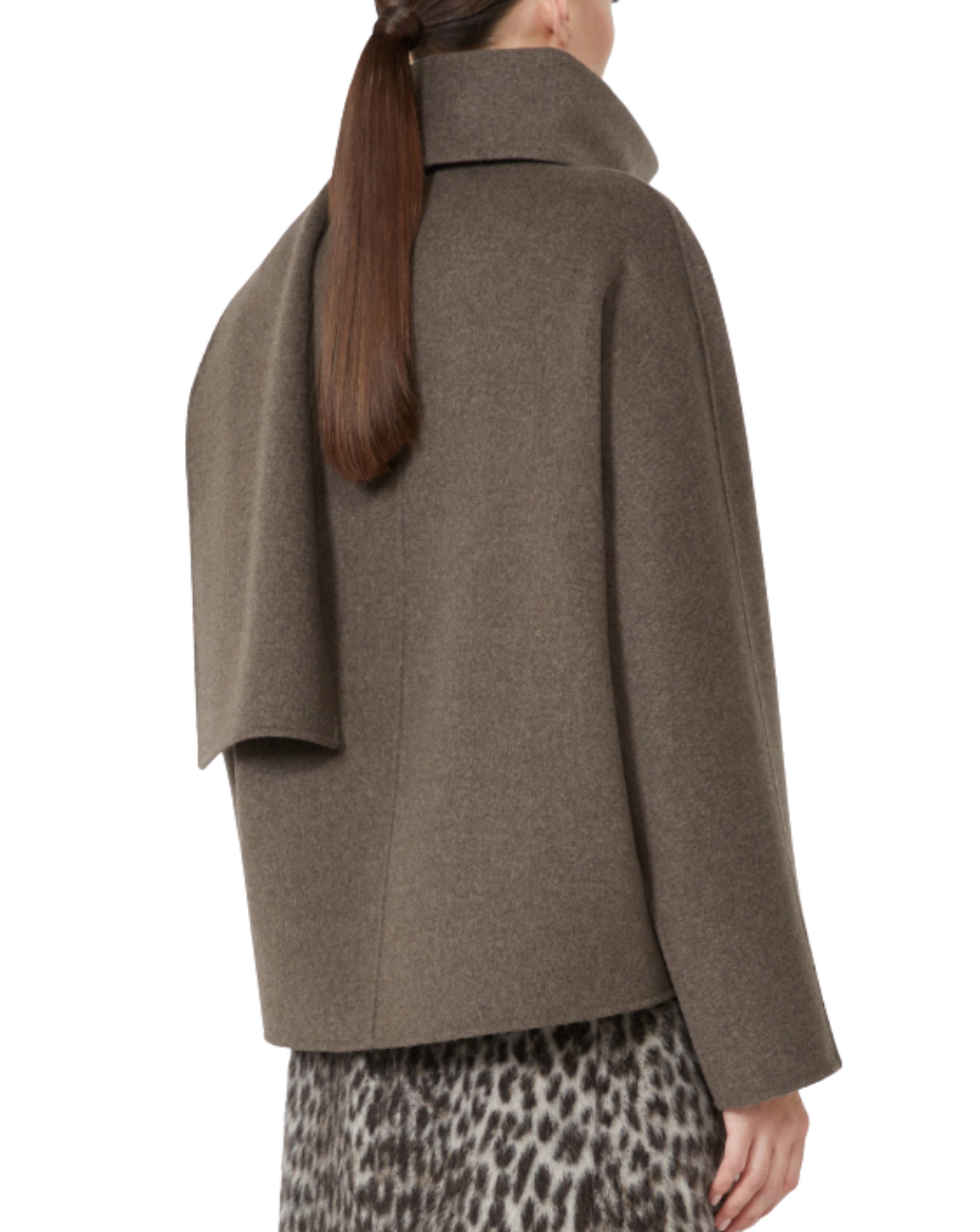 A woman shown from the back wearing a taupe-brown draped cape-style coat over a leopard-print skirt, against a plain white background.
