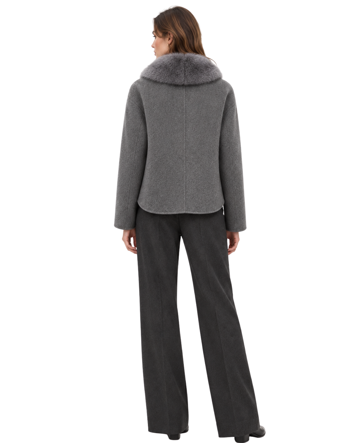 A woman shown from the back wearing a gray wool-like jacket with a large gray faux-fur collar and dark charcoal wide-leg trousers, set against a plain white background.