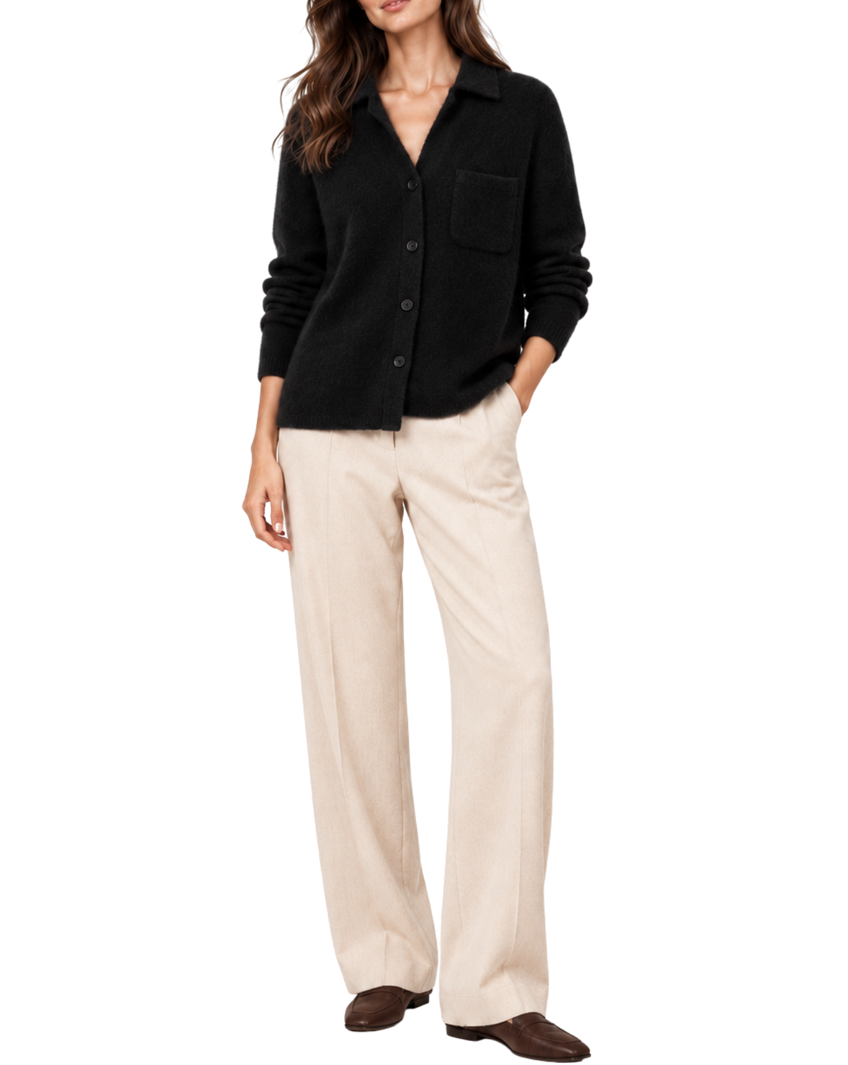 A woman modeling a black button-front knit cardigan with a chest pocket, paired with light beige wide-leg trousers and dark brown loafers, against a plain white background.