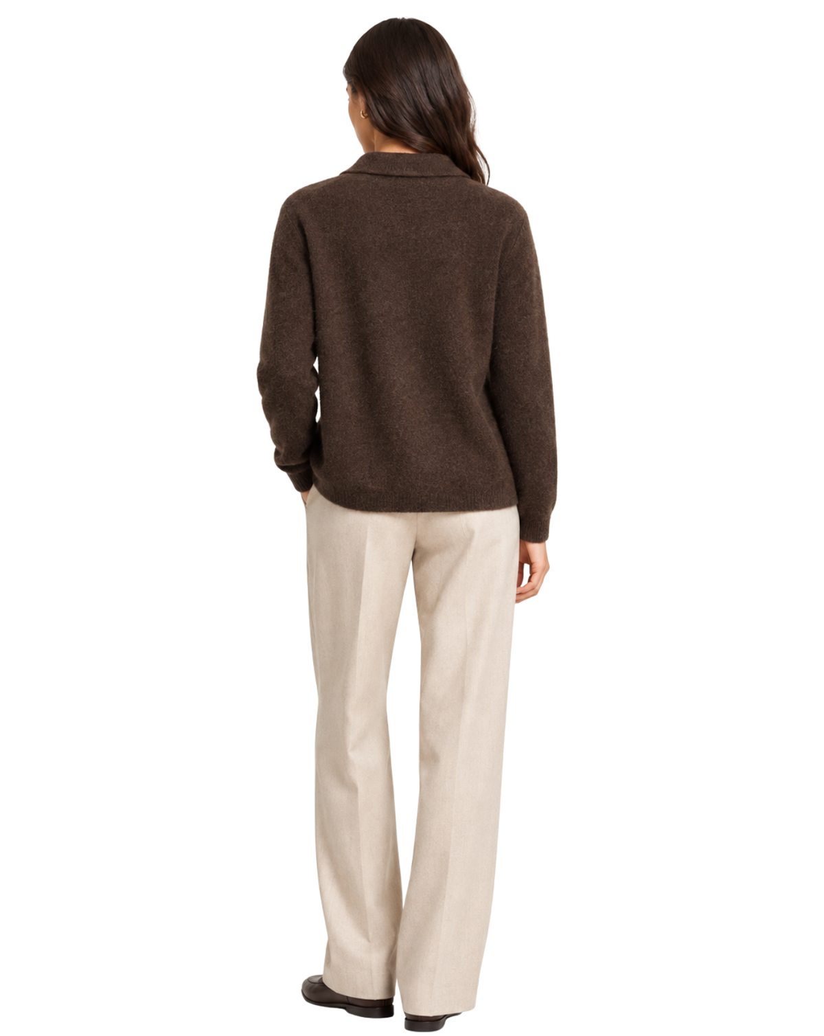 A woman shown from the back wearing a dark brown knit cardigan and light beige trousers, standing against a plain white background.