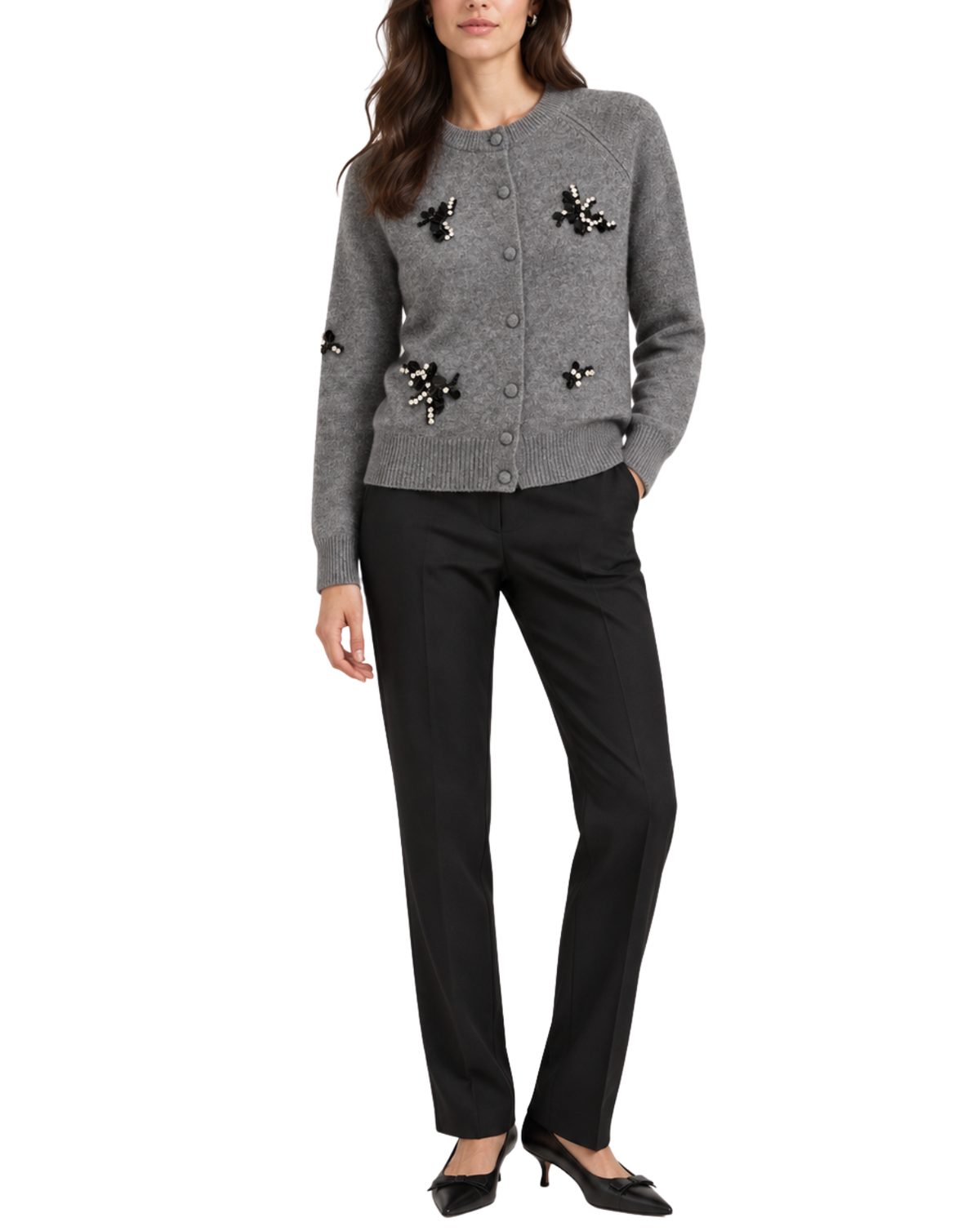 A woman models a gray button-front cardigan with black and metallic embellishments, paired with black trousers and black pointed-toe heels, against a plain white background.