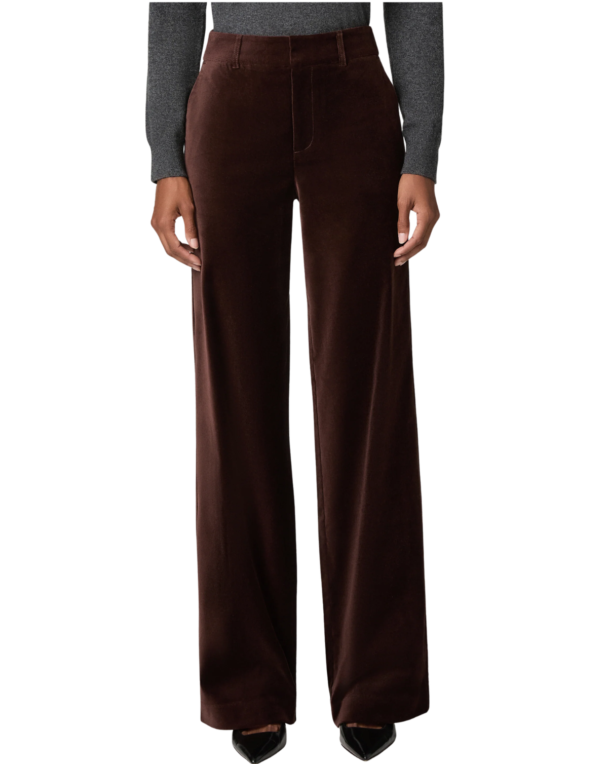 A model is shown from the waist down wearing high-waisted, wide-leg brown corduroy trousers, a gray long-sleeve top, and black pointed-toe heels against a plain white background.