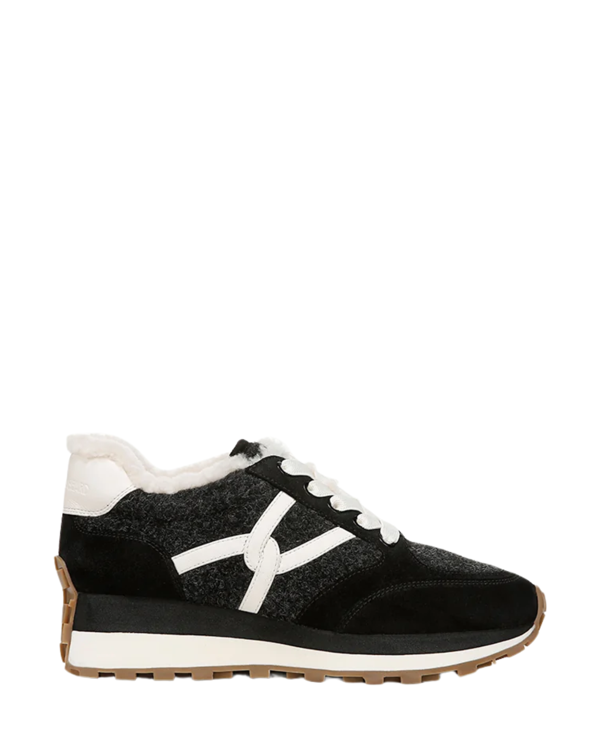 A black and white low-top sneaker with a textured knit upper, white laces, a white faux-fur collar, and a brown and white sole, shown in a side profile on a white background.