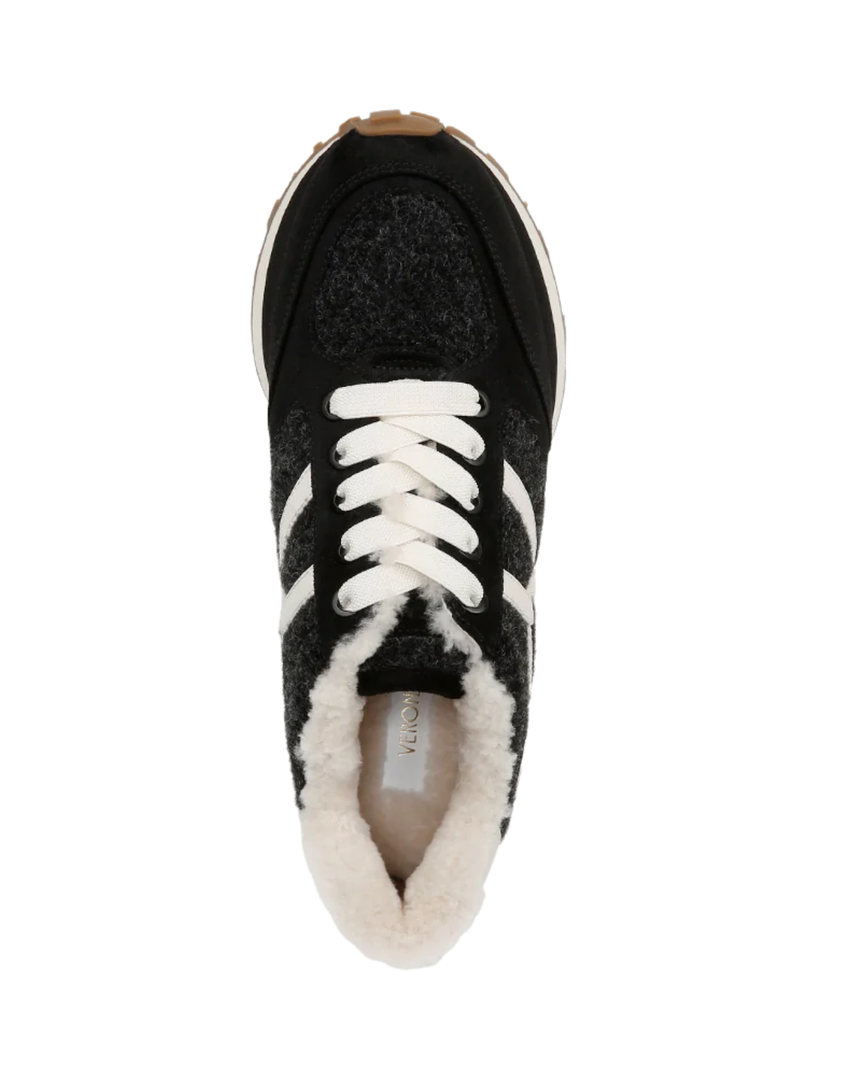 A top-down view of a black knit sneaker with white laces, white side stripes, and a white fuzzy shearling-style collar, shown on a plain white background.