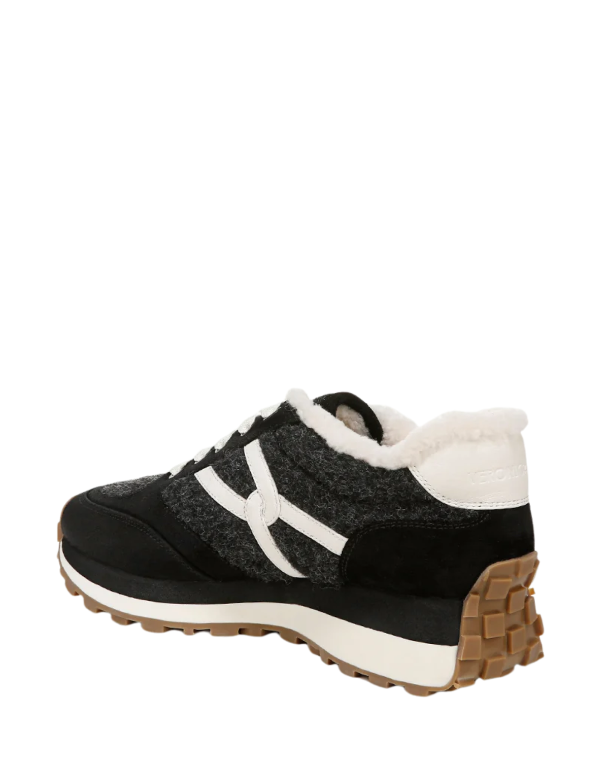 A black and dark gray sneaker with white side stripes, a white faux-fur collar, and a brown and white sole, shown from a side-rear angle on a white background.