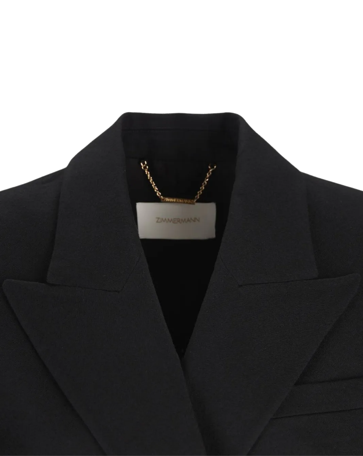 Close-up of a black blazer collar with a gold chain necklace draped inside the neckline and a white brand label reading Zimmermann.