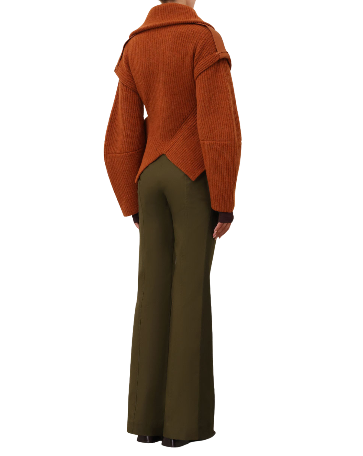 A model shown from the back wearing a rust-orange ribbed knit wrap-style cardigan and olive green wide-leg trousers, set against a plain white background.
